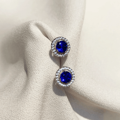 CARAT* London Gwen Sapphire Blue Round Borderset Studs - Steffans Jewellers